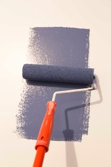 Decorator's hand painting wall with roller