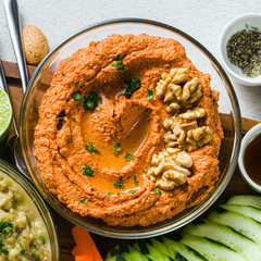  dip or spread of roasted red pepper and nuts. healthy vegan food for celebration or party . shot from above. copy space