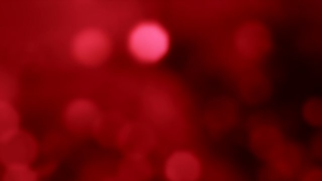 Bokeh lights glow. Christmas sparkles. Red circles glare. Abstract festive overlay.