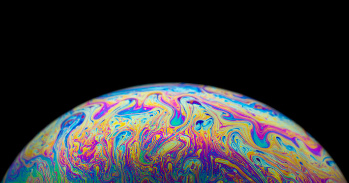 Close up picture of half soap bubble on blackground psychedelic color