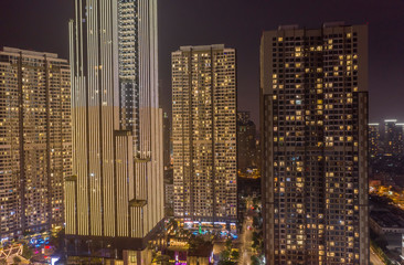 Fototapeta na wymiar Massive Modern High Density High Rise Buildings at night with lights on