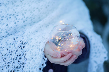 Glass ball with lights in children's hands