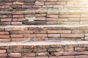 Close up old stairs made of bricks and cracks.