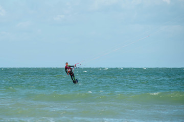 kite surfer on his hydrofoil flying over the sea