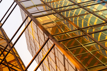 Golden building. Windows glass of modern office skyscrapers in technology and business concept....