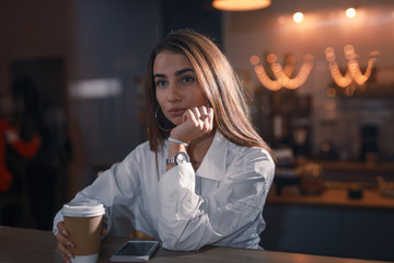 Attractive woman portrait in cafe, view through window