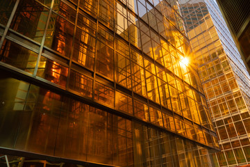 Golden building. Windows glass of modern office skyscrapers in technology and business concept. Facade design. Construction structure of architecture or engineering. Exterior for urban city background