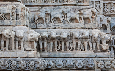 Fototapeta premium Bas-relief with Horses and Elephants at famous ancient Jagdish Temple in Udaipur, Rajasthan, India