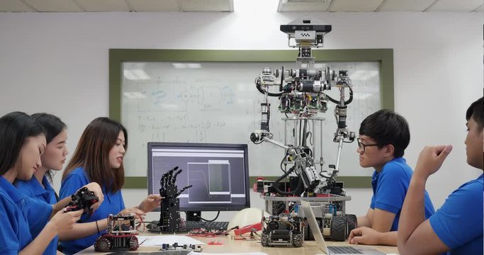 Asian engineer team assembling and testing robotics responses in laboratory. Architects design circuit and engineer meeting share technology ideas and collaborating development robot.