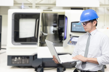 The engineer programming the robotic arms for loading the sheet metal to the hydraulic bending...