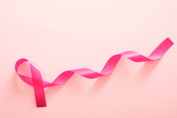 Breast cancer awareness symbol pink ribbon isolated on pink. Healthcare and medicine concept.