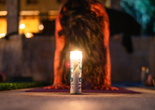 Yoga Stretching At Night By Candle Light