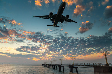 Airplane  landing at sunset