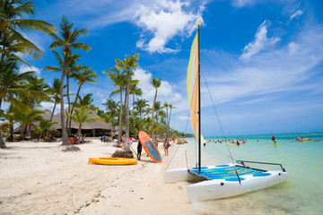 Sailboat moored at shore of tropical Bavaro beach in Sargasso sea, Punta Cana, Dominican Republic - obrazy, fototapety, plakaty