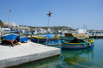 Mediterranean traditional colorful boats luzzu. Fisherman village in the south east of Malta.