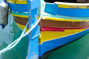 Part of colorful painted wood boat in Marsaxlokk, Malta.