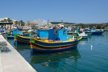 traditional fishing boats in the harbour of Marsaxlokk , Malta