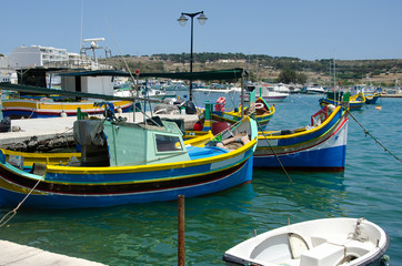 Traditional fishing boats Luzzu moored at Marsaxlokk Harbor, Malta