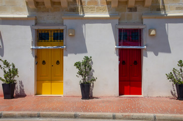 maltese vintage house with yellow and red doors. Marsaxlokk, Malta