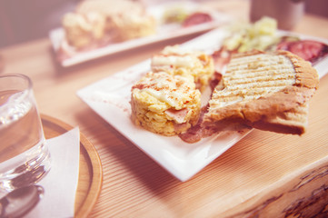 breakfast with scrambled eggs, toasts, juice and coffee