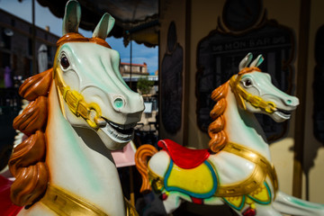 Fototapeta na wymiar Carrousel horses on the main square of Porto-Vecchio, France