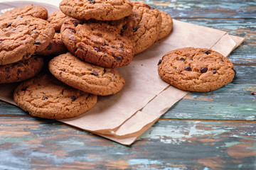 Freshly baked cookies and biscuits on wooden background. Chocolate and biscuit snacks.