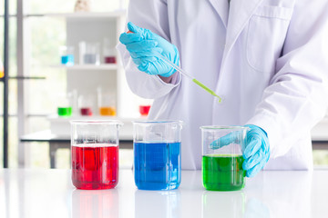Close up hand of scientist with holding injection glass laboratory chemical test  at laboratory. science. science background.
