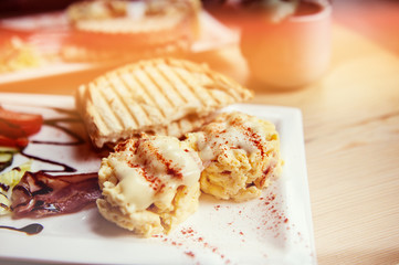 breakfast with scrambled eggs, toasts, juice and coffee