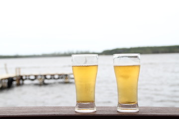 Two glasses of beer on wooden table