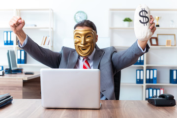 Businessman wearing mask in hypocrisy concept