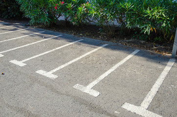 Obraz premium Public motorbike parking areas marked with white lines on the asphalt.