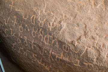 Close up of Inscriptions of Emperor Ashoka inside the cave at Maski, Raichur, India - obrazy, fototapety, plakaty