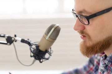 Radio host concept - Close-up of handsome man working as radio host at radio station