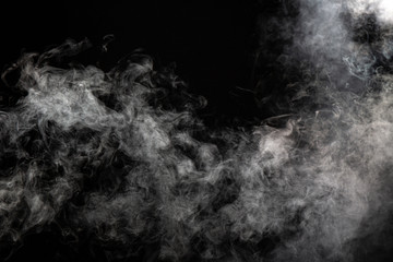 White wispy smoke on black background