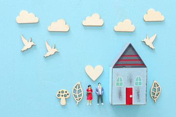 Metaphorical vintage image of a young couple with a home and family life