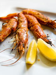 King prawns with lemon. Shrimps on a plate with lemon slices.
