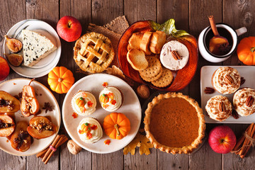 Autumn food concept. Selection of pies, appetizers and desserts. Above view table scene over a...