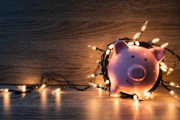 Pink piggy bank with party light, organize a party for the event where successful in saving money...