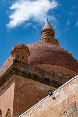Fototapeta na wymiar Dogubayazıt, Turkey: the main dome and the minaret of the famous Ishak Pasha Palace, a semi-ruined palace of Ottoman period (1685-1784), one of the most magnificent historical buildings of the country