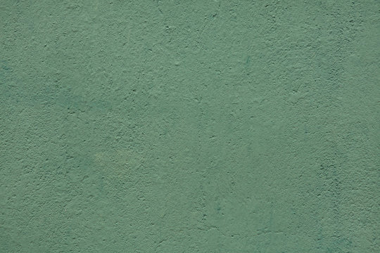 Green painted stucco wall.