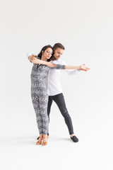 Passionate couple dancing social danse kizomba or bachata or semba or taraxia on white background with copy space