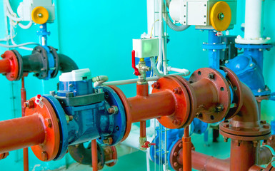 Water pumping station, industrial interior and pipes.