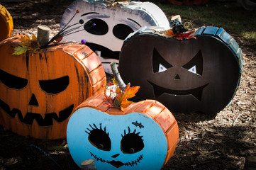 Pictures of various pumpkin carved faces on wood themed pumpkin.