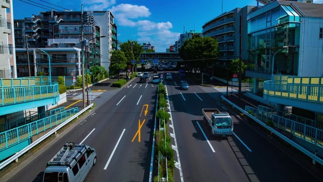 A timelapse of downtown street at Kanpachi avenue in Tokyo daytime wide shot panning