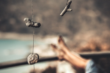Handmade Decoration Amulet and Young Woman Legs and Coastal Bottle Beach on Phangan Island Thailand...