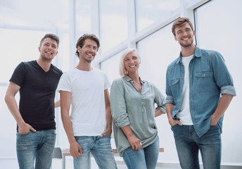 group of successful young people standing in the office