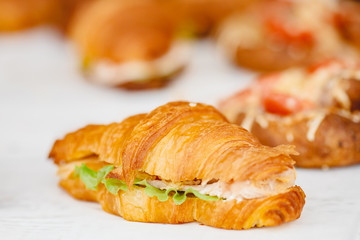 Sandwich croissants with green salad and jamon meat, european breakfast. Catering concept