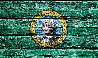 The national flag of the US state Washington in against a black charred wooden wall on the day of independence. Political and religious disputes, fire department and firefighters.