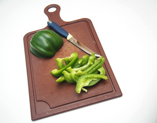 Green pepper fruit lies on the cutting Board.