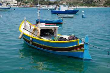 Fototapeta na wymiar Luzzu Boats in Marsaxlokk Port in Malta